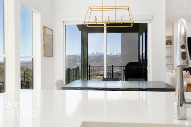 dining space with a mountain view, plenty of natural light, and built in shelves
