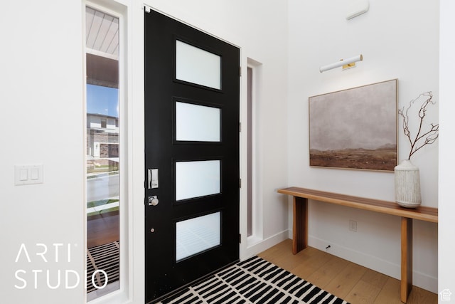 foyer entrance featuring wood finished floors and baseboards