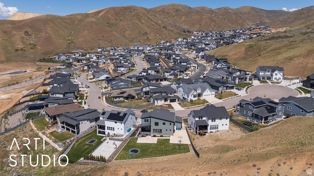 aerial view of property and surrounding area with nearby suburban area and mountains