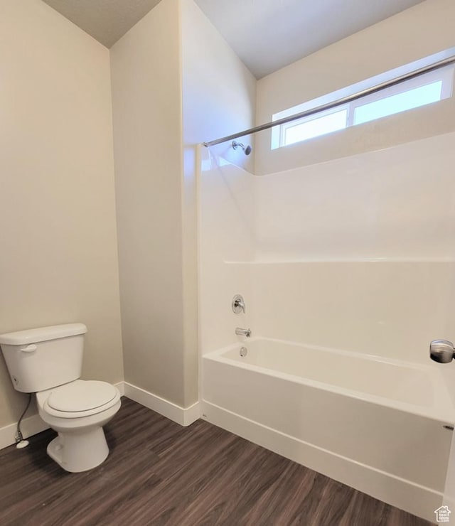 14643 S Mckellen Dr W Unit D302, Herriman, UT 84096 - full bathroom featuring baseboards, wood finished floors, toilet, and washtub / shower combination