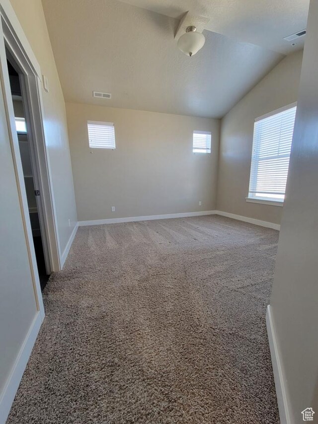 14643 S Mckellen Dr W Unit D302, Herriman, UT 84096 - carpeted spare room featuring healthy amount of natural light, baseboards, and lofted ceiling