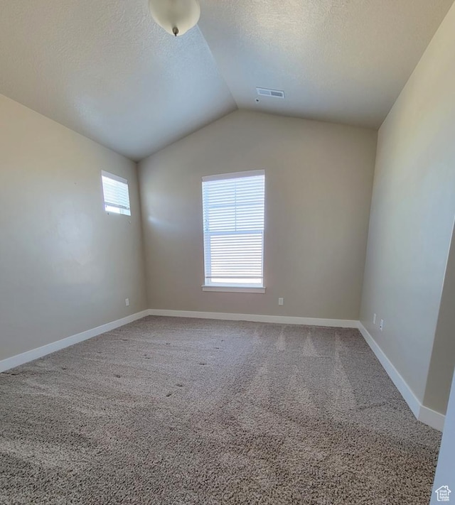 14643 S Mckellen Dr W Unit D302, Herriman, UT 84096 - carpeted spare room with vaulted ceiling, a textured ceiling, and baseboards
