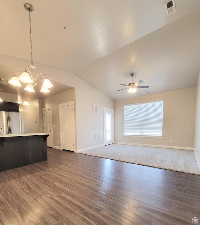 14643 S Mckellen Dr W Unit D302, Herriman, UT 84096 - unfurnished living room with baseboards, dark wood-style flooring, a ceiling fan, vaulted ceiling, and a chandelier