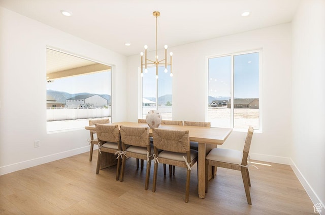 dining space with a chandelier, healthy amount of natural light, light wood-type flooring, and recessed lighting