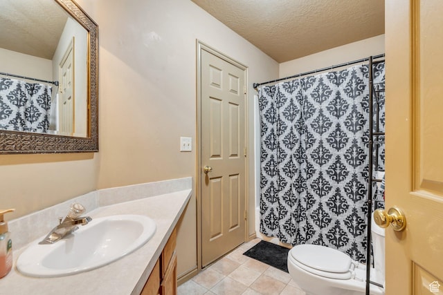 bathroom with a textured ceiling, vanity, toilet, tile patterned flooring, and a shower with curtain