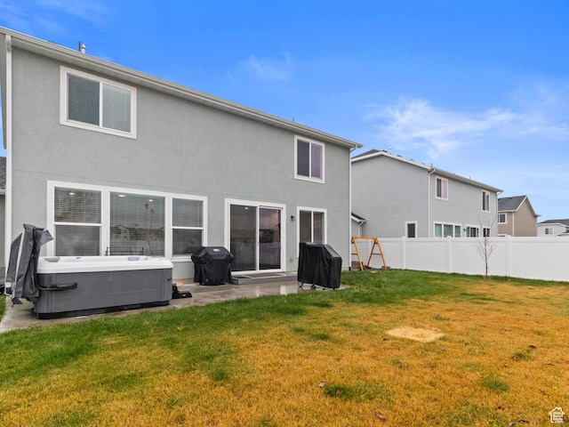 826 W 700 S, American Fork, UT 84003 - back of house featuring a hot tub, stucco siding, and a patio