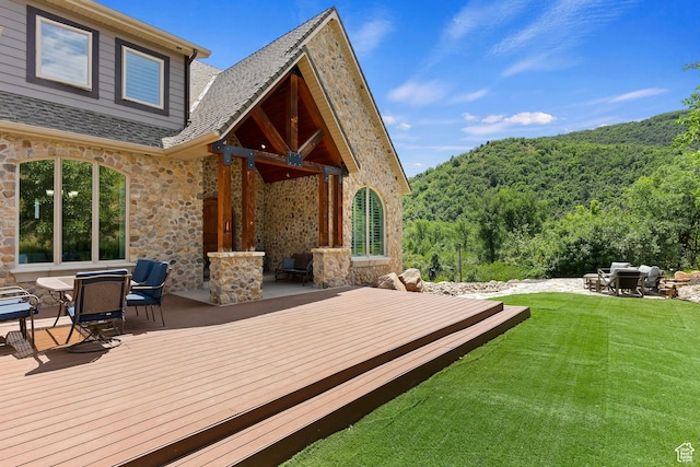 2333 S Falcon Way, Huntsville, UT 84317 - wooden deck featuring a lawn, a wooded view, and outdoor dining area