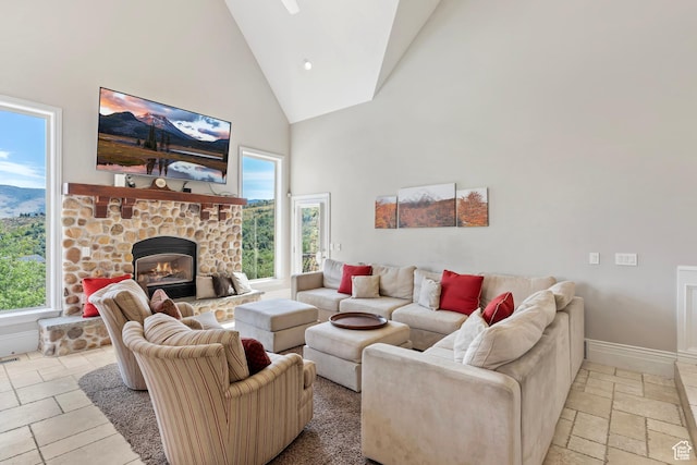 2333 S Falcon Way, Huntsville, UT 84317 - living room with high vaulted ceiling, baseboards, stone tile flooring, and a stone fireplace