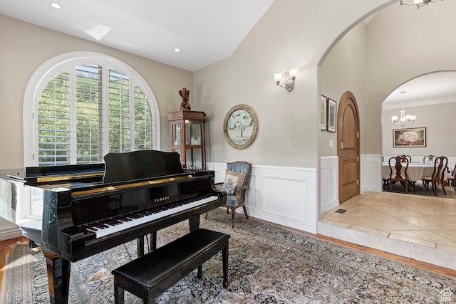 2333 S Falcon Way, Huntsville, UT 84317 - sitting room featuring arched walkways, wainscoting, a chandelier, a decorative wall, and ornamental molding