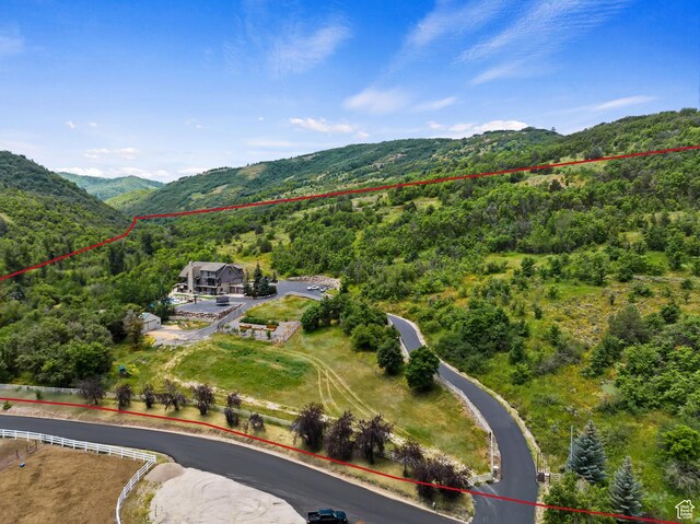 2333 S Falcon Way, Huntsville, UT 84317 - aerial view of property's location with a heavily wooded area, property boundaries highlighted, and a mountainous background