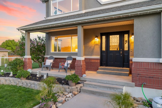 2859 W Country Classic Dr, Bluffdale, UT 84065 - exterior entry at dusk featuring a porch and stucco siding