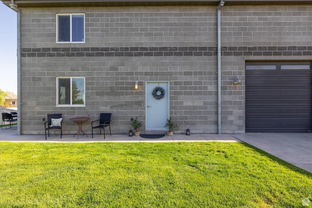 2859 W Country Classic Dr, Bluffdale, UT 84065 - doorway to property with concrete block siding, a lawn, and an attached garage