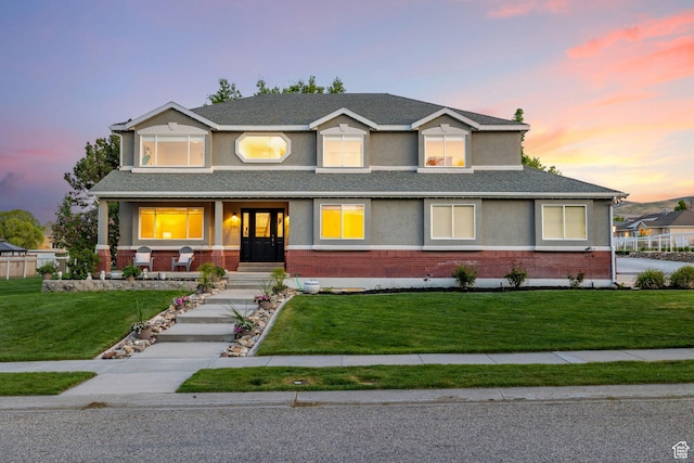 2859 W Country Classic Dr, Bluffdale, UT 84065 - view of front facade featuring brick siding, a lawn, stucco siding, and a shingled roof