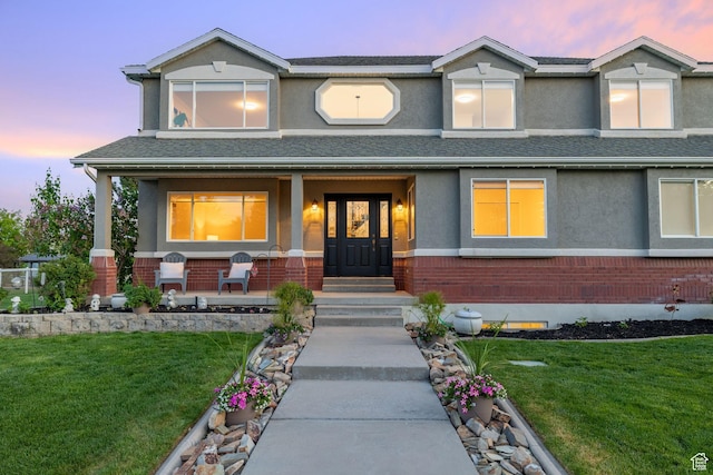 2859 W Country Classic Dr, Bluffdale, UT 84065 - view of front of property with a porch, stucco siding, a lawn, and brick siding