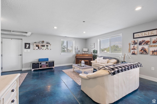 2859 W Country Classic Dr, Bluffdale, UT 84065 - living area with finished concrete floors, recessed lighting, a textured ceiling, and baseboards