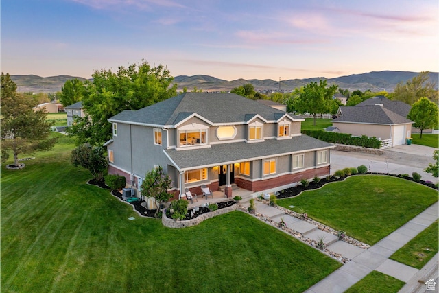 2859 W Country Classic Dr, Bluffdale, UT 84065 - traditional-style house with a garage, a front yard, covered porch, and a mountain view