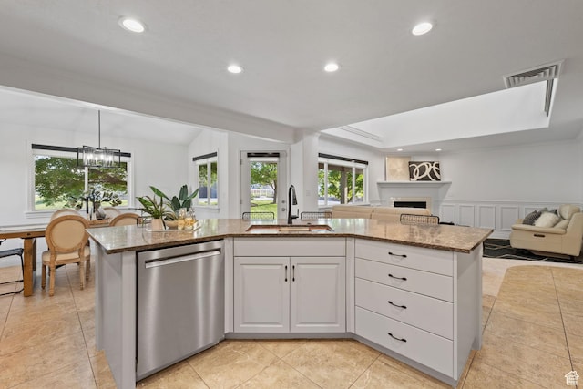 2859 W Country Classic Dr, Bluffdale, UT 84065 - kitchen featuring a sink, stainless steel dishwasher, open floor plan, light stone countertops, and recessed lighting