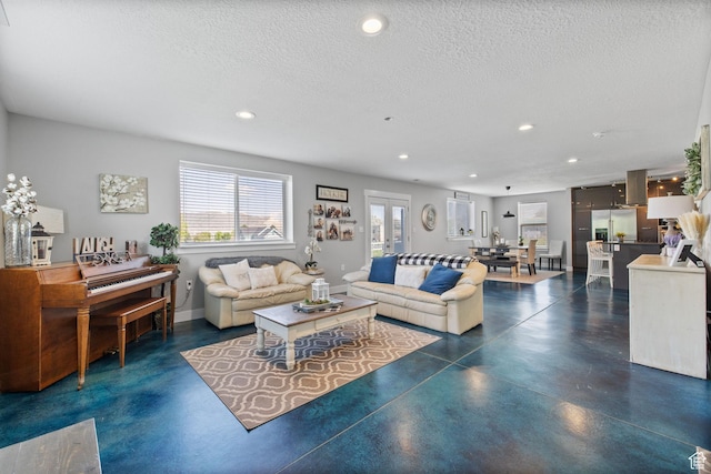 2859 W Country Classic Dr, Bluffdale, UT 84065 - living room with finished concrete flooring, recessed lighting, a textured ceiling, and baseboards