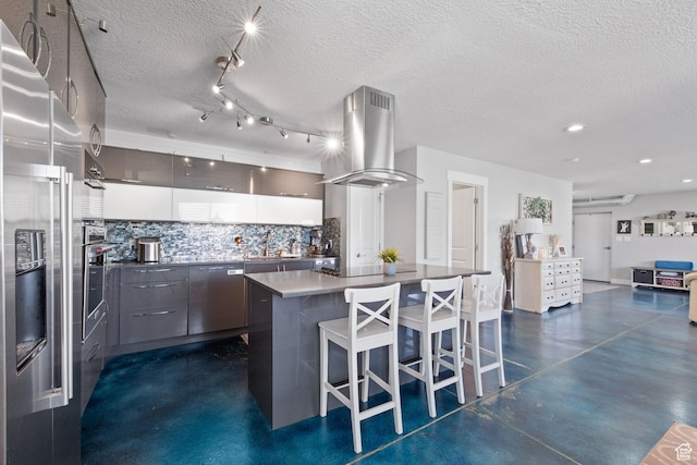 2859 W Country Classic Dr, Bluffdale, UT 84065 - kitchen with island range hood, stainless steel appliances, backsplash, a kitchen bar, and a kitchen island