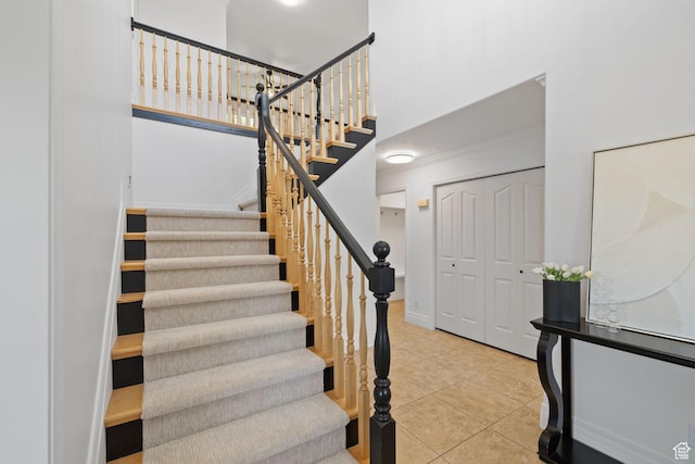 2859 W Country Classic Dr, Bluffdale, UT 84065 - stairs with tile patterned flooring, a high ceiling, baseboards, and crown molding