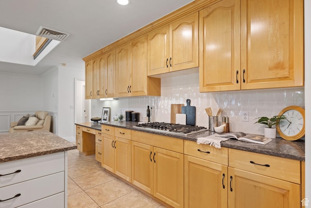2859 W Country Classic Dr, Bluffdale, UT 84065 - kitchen featuring stainless steel gas cooktop, decorative backsplash, dark stone countertops, light tile patterned floors, and crown molding