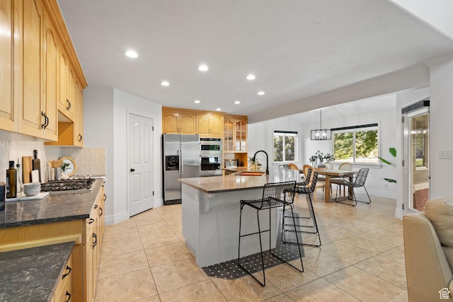2859 W Country Classic Dr, Bluffdale, UT 84065 - kitchen with appliances with stainless steel finishes, a sink, a breakfast bar area, recessed lighting, and baseboards