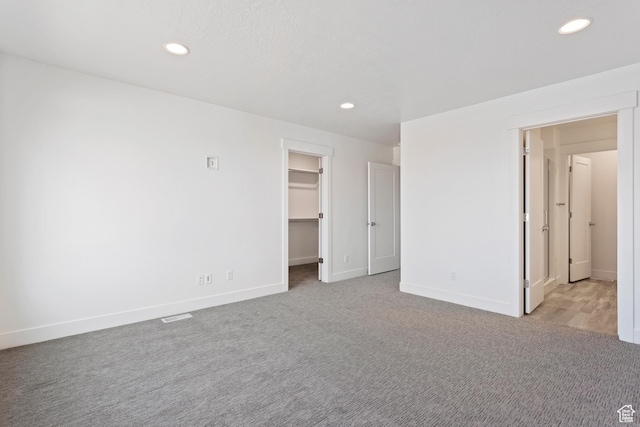 1667 W 2770 S Unit 206, Syracuse, UT 84075 - unfurnished bedroom with recessed lighting, a spacious closet, baseboards, and carpet floors