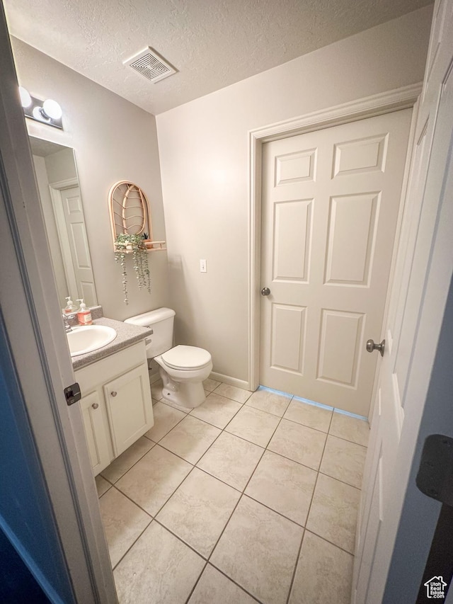1154 S 1430 E, Provo, UT 84606 - bathroom featuring tile patterned flooring, toilet, vanity, and a textured ceiling