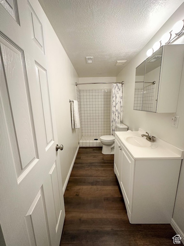 1154 S 1430 E, Provo, UT 84606 - full bathroom with wood finished floors, a textured ceiling, a tile shower, toilet, and vanity
