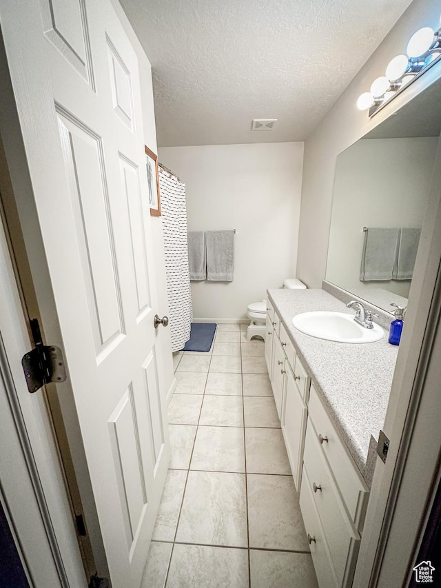 1154 S 1430 E, Provo, UT 84606 - bathroom with vanity, a textured ceiling, toilet, tile patterned flooring, and baseboards