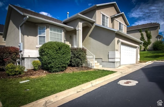 1154 S 1430 E, Provo, UT 84606 - view of front of house featuring stucco siding, a front yard, an attached garage, and asphalt driveway