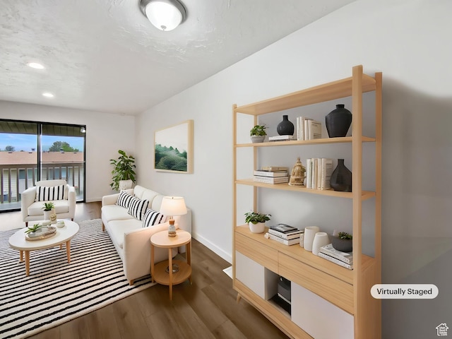 sitting room with dark wood finished floors, baseboards, and recessed lighting