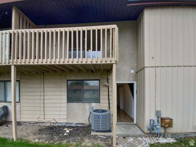 rear view of house with a balcony and central air condition unit