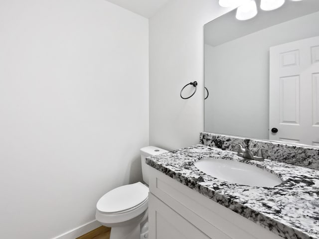 bathroom featuring toilet and vanity