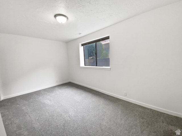 empty room with carpet and baseboards