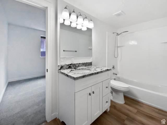 full bath with  shower combination, vanity, toilet, and wood finished floors