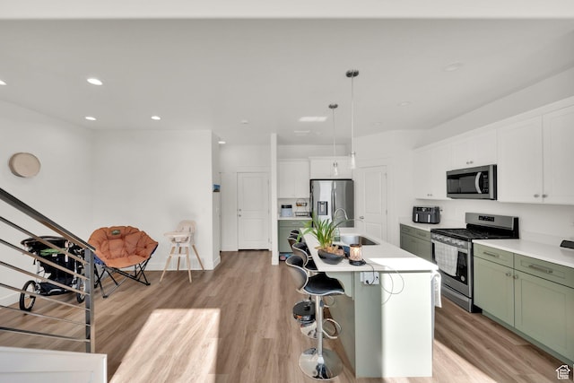 1293 N 3960 W Unit 457, Lehi, UT 84043 - kitchen with appliances with stainless steel finishes, green cabinets, a sink, light wood-type flooring, and recessed lighting