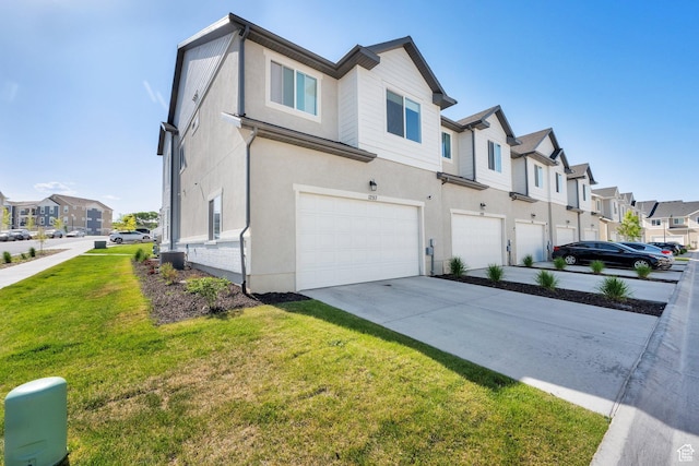 1293 N 3960 W Unit 457, Lehi, UT 84043 - view of side of home featuring a residential view, a garage, stucco siding, and a yard
