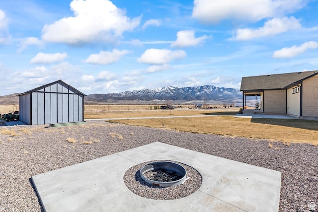 2201 S 380 W, Richfield, UT 84701 - view of patio with a fire pit, a storage shed, a mountain view, and an outdoor structure