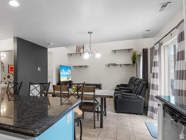920 W Stonehaven Dr, North Salt Lake, UT 84054 - kitchen featuring dishwasher, a breakfast bar, open floor plan, light tile patterned floors, and a chandelier