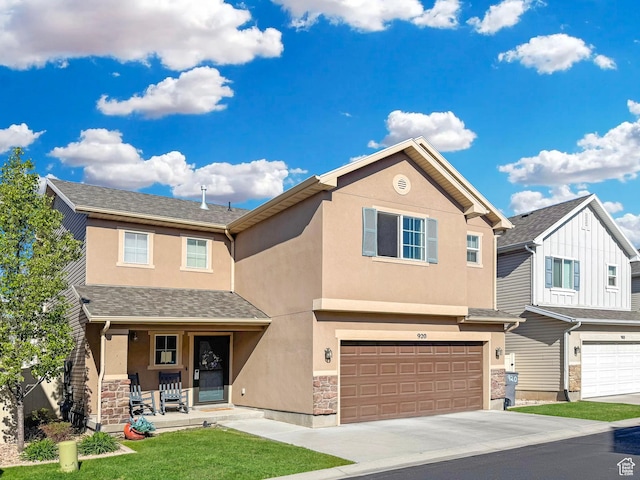 920 W Stonehaven Dr, North Salt Lake, UT 84054 - townhome / multi-family property with stucco siding, a porch, an attached garage, concrete driveway, and stone siding