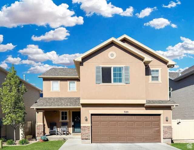920 W Stonehaven Dr, North Salt Lake, UT 84054 - view of front of home with stone siding, stucco siding, a porch, and concrete driveway