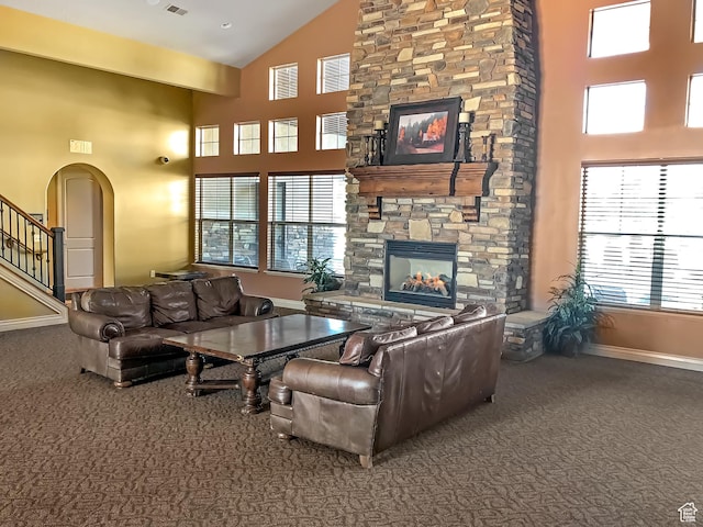 920 W Stonehaven Dr, North Salt Lake, UT 84054 - living room featuring carpet, high vaulted ceiling, a stone fireplace, arched walkways, and baseboards