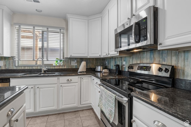 920 W Stonehaven Dr, North Salt Lake, UT 84054 - kitchen with appliances with stainless steel finishes, a sink, white cabinetry, and light tile patterned floors