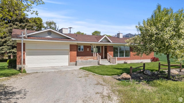 3647 Maple Creek Rd N, Franklin, ID 83237 - ranch-style home with a garage, a porch, a chimney, and brick siding