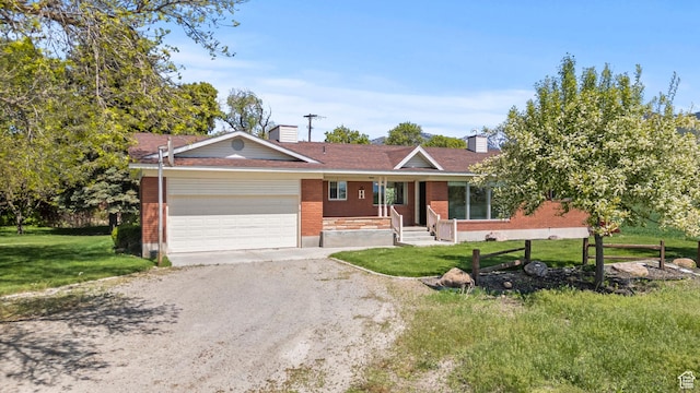 3647 Maple Creek Rd N, Franklin, ID 83237 - single story home with covered porch, an attached garage, driveway, a front yard, and a chimney