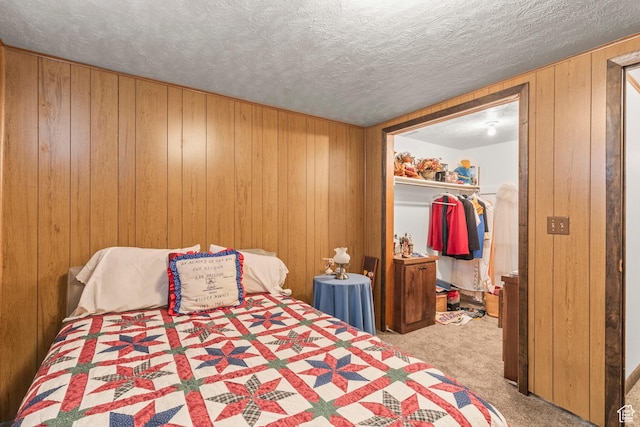 3647 Maple Creek Rd N, Franklin, ID 83237 - bedroom featuring carpet flooring, wood walls, a spacious closet, a textured ceiling, and a closet