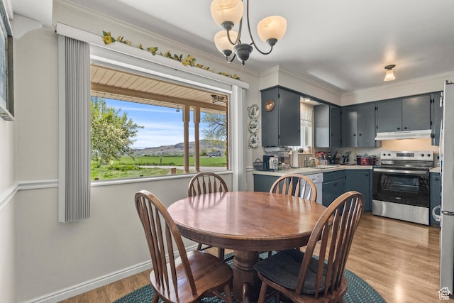 3647 Maple Creek Rd N, Franklin, ID 83237 - dining space featuring light wood-style flooring, ornamental molding, baseboards, and a chandelier