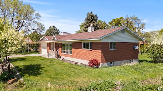 3647 Maple Creek Rd N, Franklin, ID 83237 - view of front of house with an attached garage, a front lawn, and brick siding
