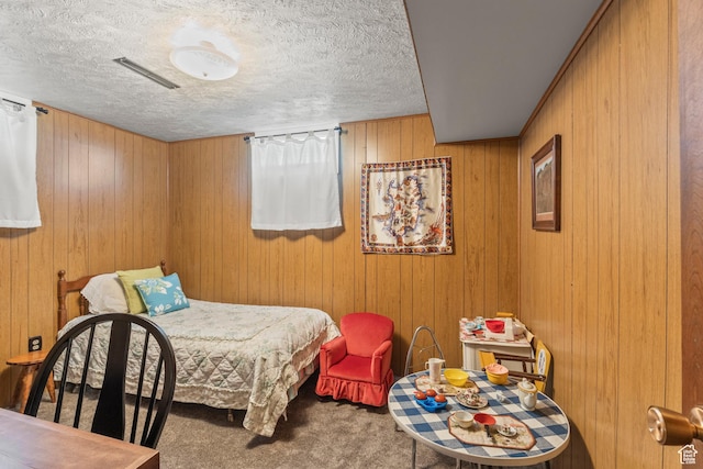 3647 Maple Creek Rd N, Franklin, ID 83237 - bedroom featuring carpet flooring, a textured ceiling, and wooden walls